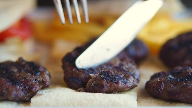 Close-up of Kofta with Fork and Knife.
