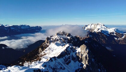 Snow-capped mountain peaks, valley clouds