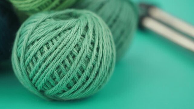 Creating with green yarn and knitting needles for beginners - Powered by Adobe