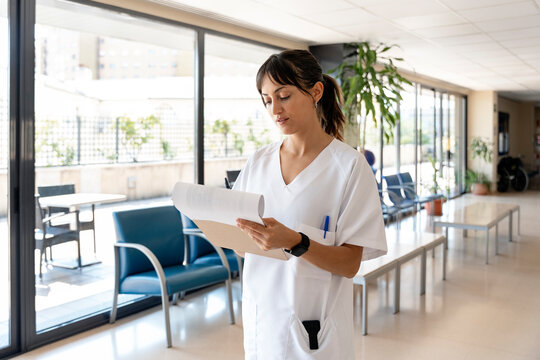 Nurse checking medical records in hospital waiting room