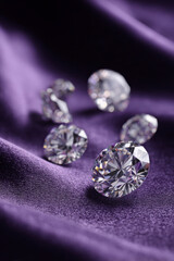 Sparkling gems: a collection of brilliant gems on elegant purple fabric.
