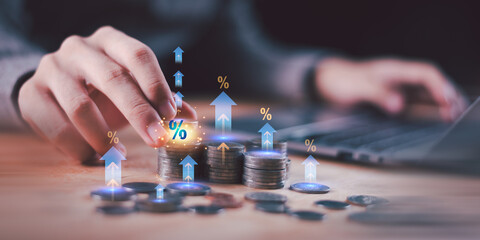 Stacked coins with glowing percentage symbols and upward arrows represent interest rate increase,...
