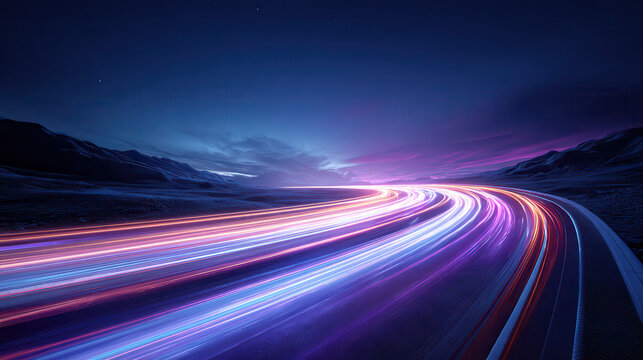 Vibrant light trails on a winding highway at night