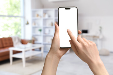 Blurred view of light living room with shelf unit, sofa and workplace