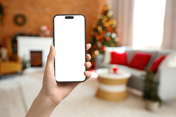 Blurred view of living room with sofa, fireplace and Christmas trees