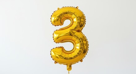 Gold foil number three balloon floating against a white background