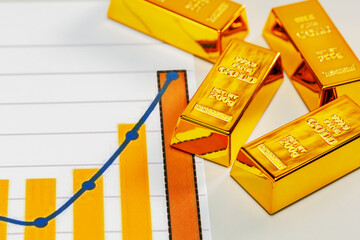 Growth chart with gold bars. Rising gold price concept. Selective focus.