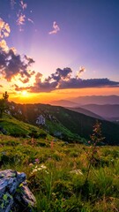 Obraz premium Sunset over mountain meadow, vibrant colors, wildflowers