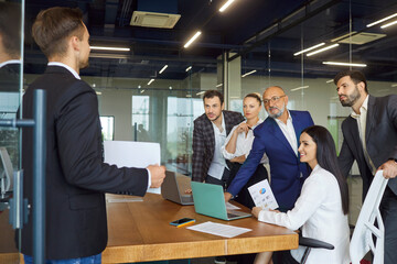 Business project presentation from employee to dedicated team on meeting in office boardroom. Man...