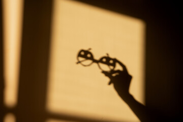 Woman's hand holding glasses in a shape of pumpkins.