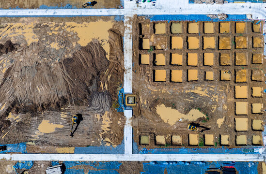 Aerial top view of construction site foundation work
