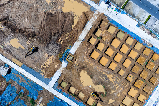 Aerial top view of construction site foundation work