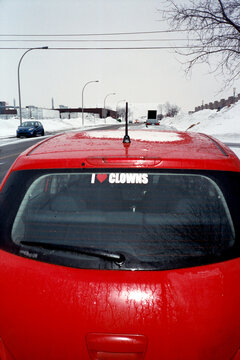 Bright red car with "I heart clowns" sticker 
