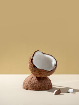 A cracked coconut displays its fresh white flesh
