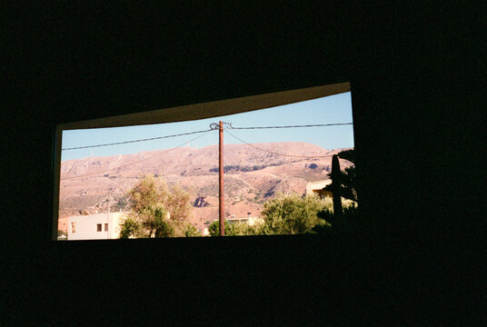 Property window with view of desert mountain in Greece 
