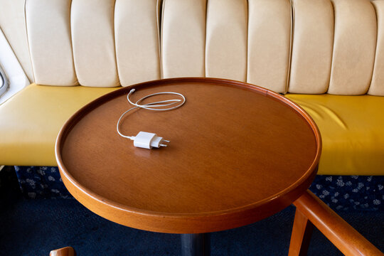 Table with phone charger at cruise boat lounge