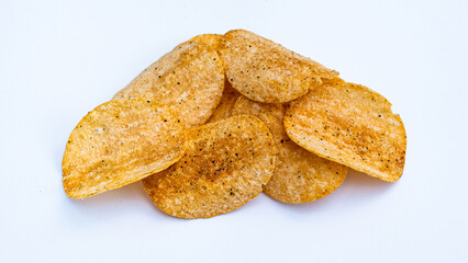 A small pile of perfectly cooked, golden-brown potato chips, dusted with dark seasoning and isolated against a pure white background, ready to eat.