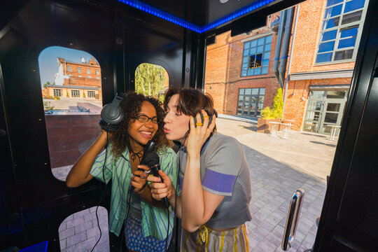 Happy friends singing karaoke together