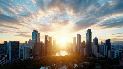 Obraz premium Stunning skyline at sunset with vibrant clouds reflecting warm colors over cityscape