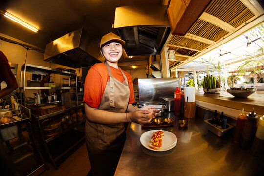 Portrait of smiling cook preparing dish