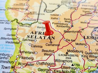 Fototapeta premium View of Carnarvon, is a small town in the Northern Cape Province of South Africa, on a geographical map of Africa, marked with red pushpin
