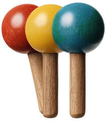 Three wooden-handled objects, each with a brightly colored sphere on top, stand together