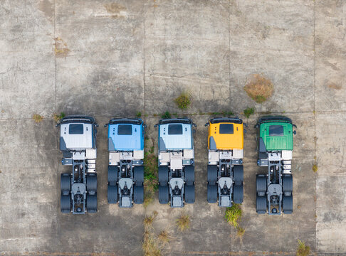 New Semi Trucks with Colorful Cabs on a Concrete Lot