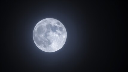Fototapeta premium Full moon glowing brightly against a dark night sky