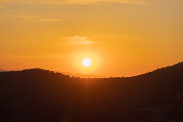 Atmospheric abstract photograph of a sunset over the natural landscapes of Bosnia and Herzegovina. Featuring vivid gradients, soft silhouettes, and warm tones that evoke emotion and tranquility