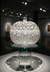 Ornate glass vessel displayed on pedestal