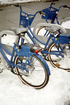 Blue rental bikes in the snow