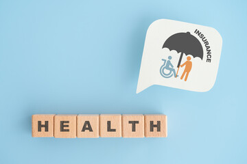 For health insurance, retirement, elderly care, savings money concept, elderly and disabled people with umbrella icon on real white speech bubble paper and HEALTH text on wooden cube block