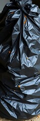 Full black trash bag with soiled contents, tied securely, awaiting collection for proper waste disposal, waste disposal,  tied bag