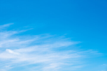 A bright, clear blue sky meets a glowing white horizon, suggesting a serene, open, and with sunlight of beautiful cloudy sky. landscape or abstract background.
