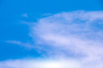 A bright, clear blue sky meets a glowing white horizon, suggesting a serene, open, and with sunlight of beautiful cloudy sky. landscape or abstract background.