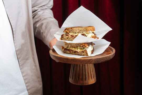 Stacked toasted sandwiches with melted cheese and meat