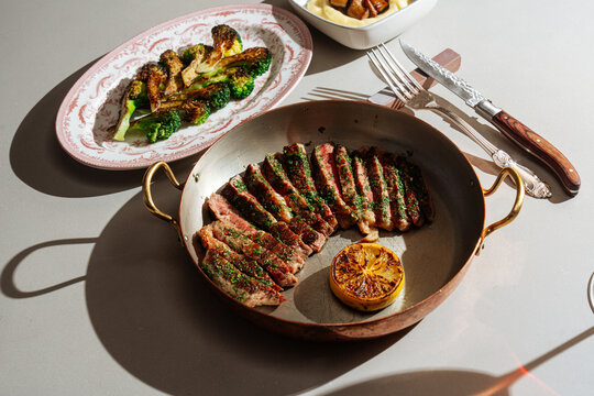 Grilled steak with herbs, roasted vegetables, and mashed potatoes