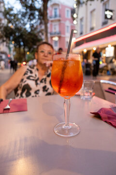 Aperol Spritz With Blurred Elderly Woman  Behind