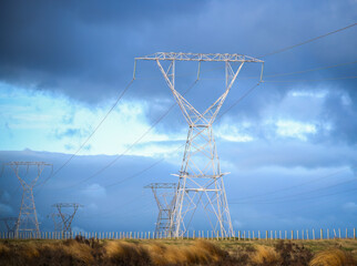 Power pylons and power lines along Desert Road at sunrise. Tongariro national park. New Zealand.