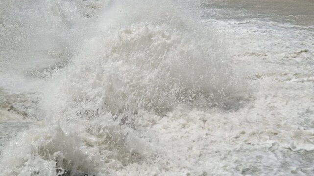 row of chute dentate blocks in concrete water spillway channel slope slowing down splashing flow of water running down.