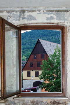 View through an open window of a house in a village