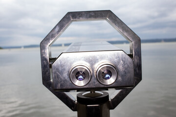 Large binoculars overlooking a lake