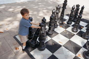 A Toddler Plays Chess In The Park