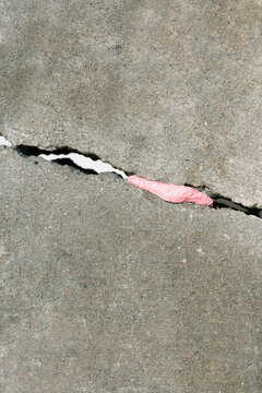 Conceptual photo of fixing broken crack stone pink sticky bubble gum