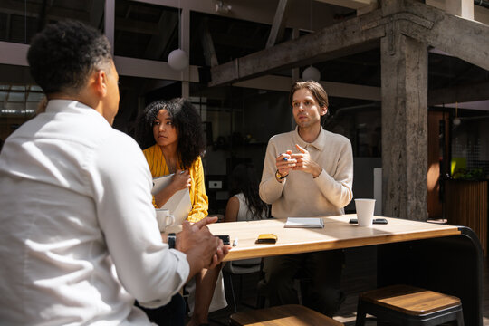 Young professionals discussing ideas during a collaborative talk