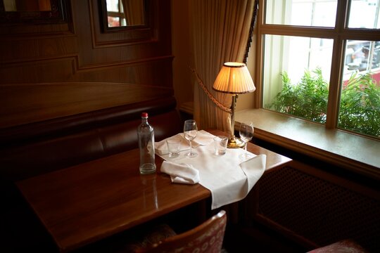 Cozy Dining Table after Dinner by the Window in an Elegant Restaurant