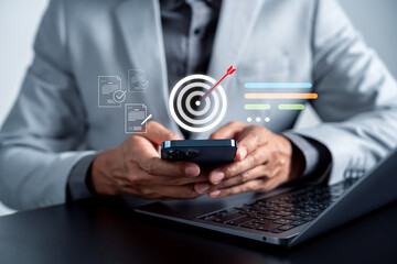 Businessman using smartphone with digital target and checklist, goal setting, workflow planning, task execution, productivity management, and strategic focus.