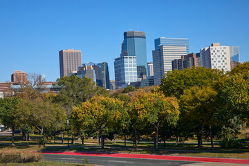 Skyline of city with large buildings and towers with a park in the foreground