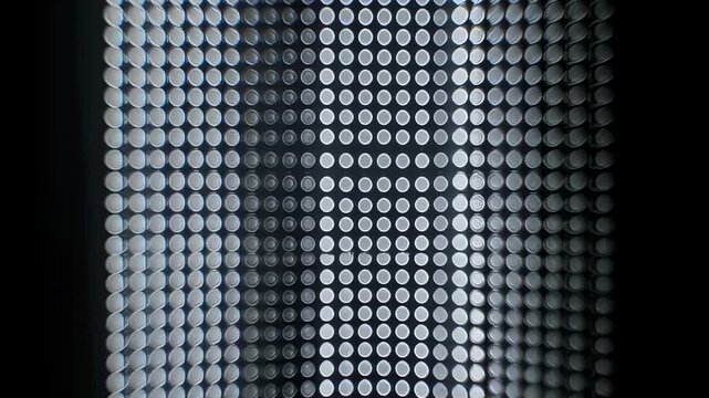 Circular gridded pattern with light variations on dark