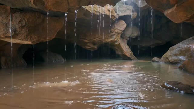 Scene of water falling over rocks in the cave